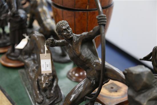 A bronze figure of a nude archer standing upon a rocky outcrop, 22in.